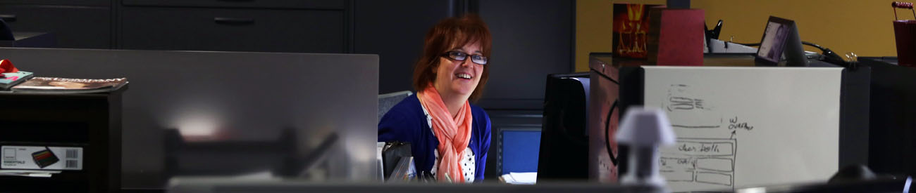 Woman sitting at her computer smiling