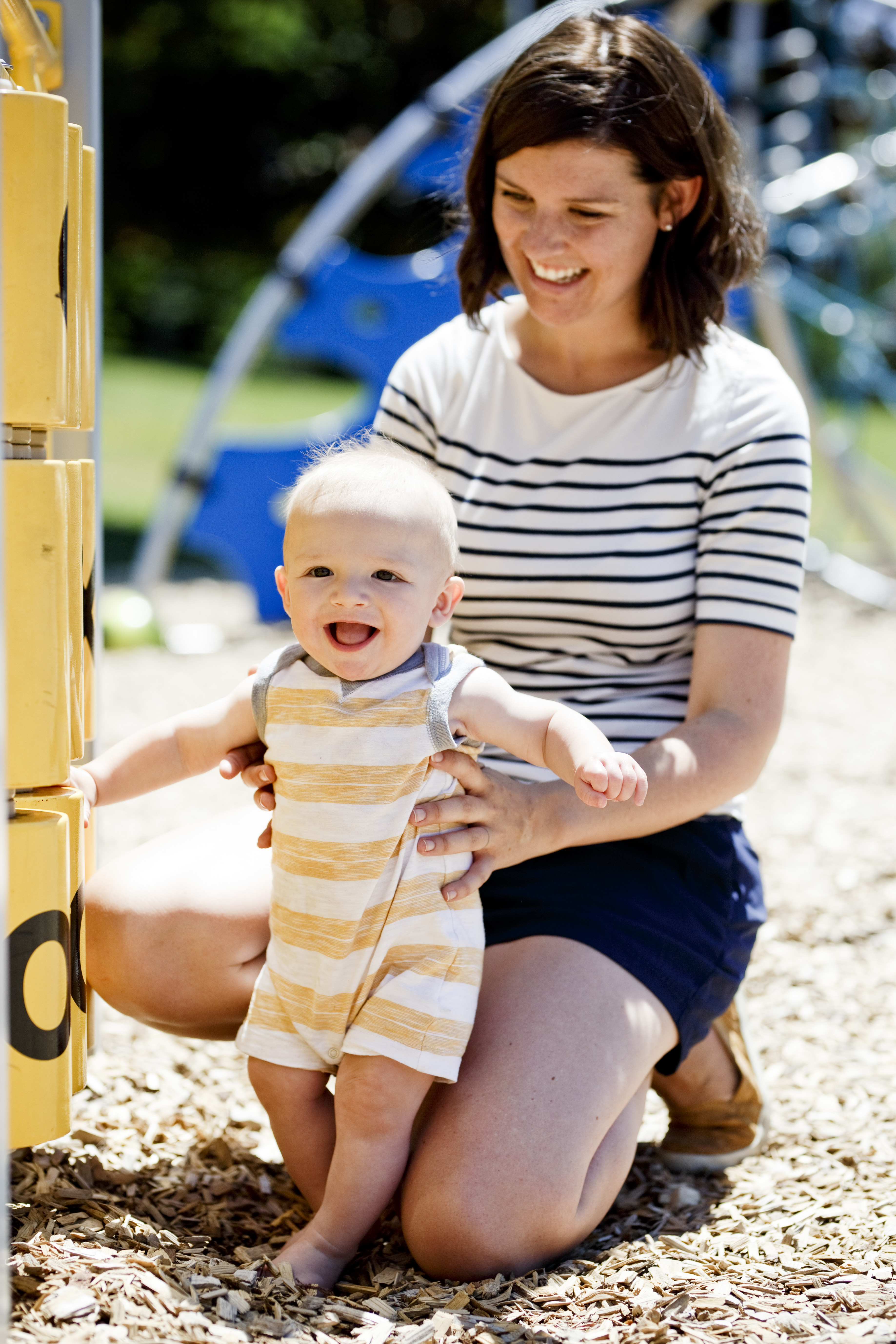 Mom and infant son playing in the playground.